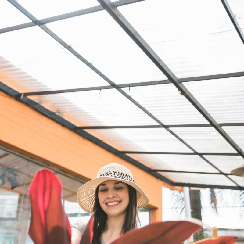 Close Up Red Leaves Front Happy Woman Standing Greenhouse 1 Min